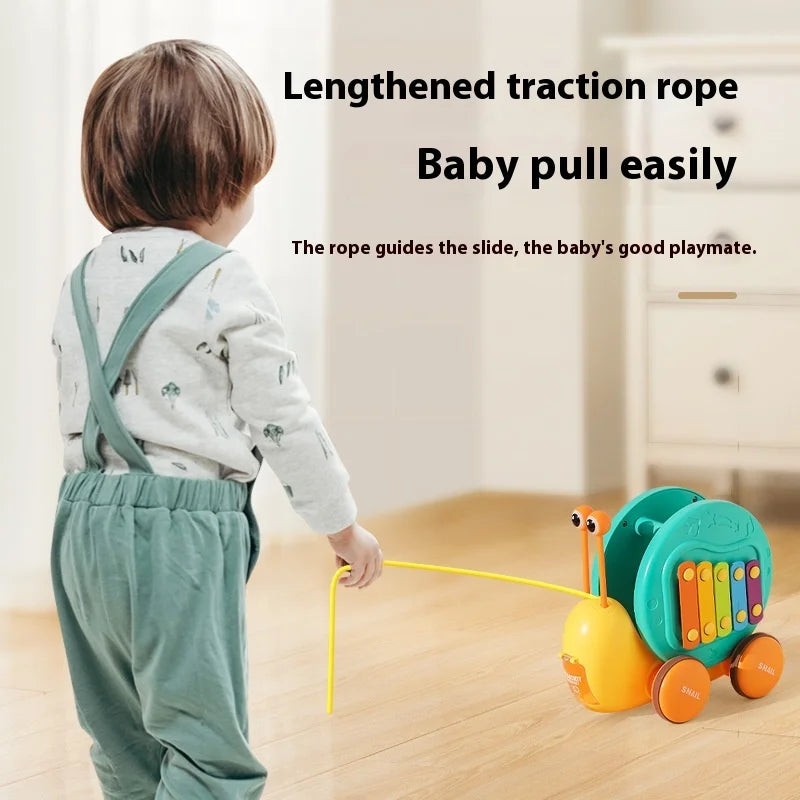 Juguete de cuerda deslizante para niños con forma de caracol para aprender a caminar, carro juguete de remolque